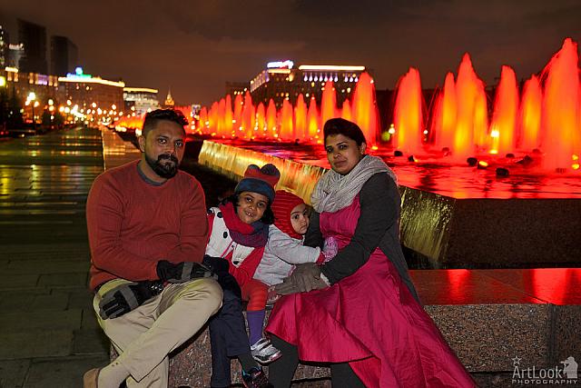 At the Red Illuminated Fountains in Victory Park at Night