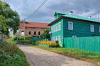 Green Wooden House on a Small Passage
