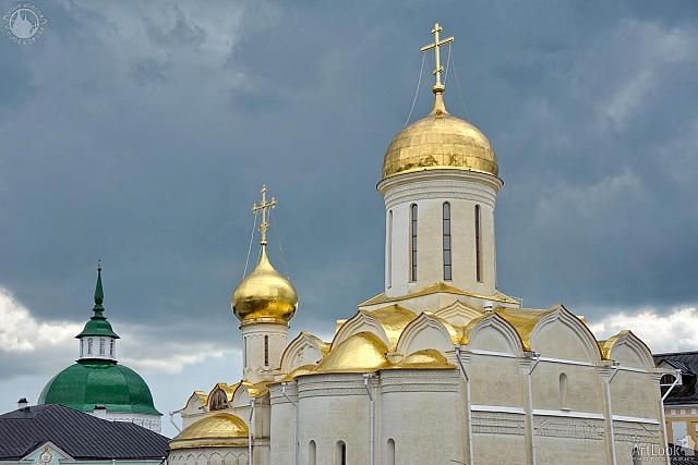 Golden Domes of Trinity Cathedral Against Dark Rain Clouds