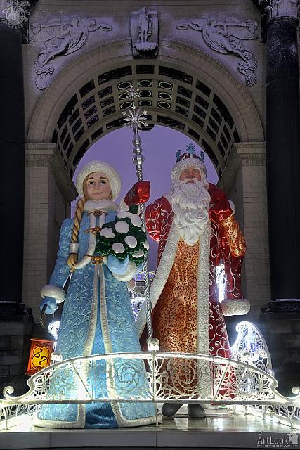 Ded Moroz and Snegurochka at Triumphal Gate in Morning Twilight