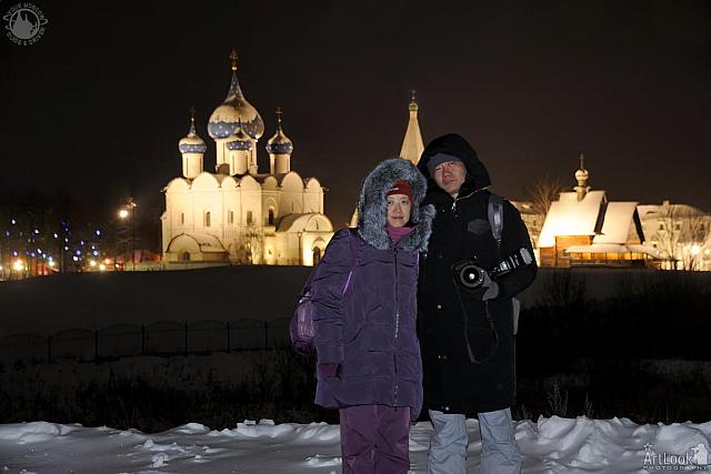 In Background of Illuminated Suzdal Kremlin in Winter Evening