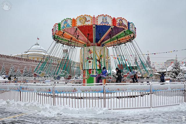 Riding on a Festive Carousel on Red Square in Snowfall