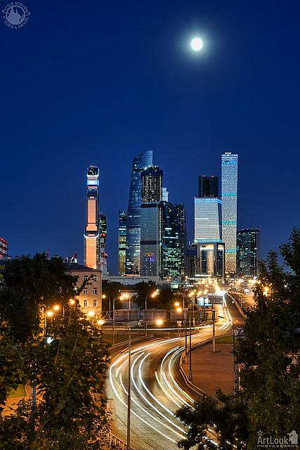 Moskva-City Skyscrapers and Car Light Trails Under Moonlight