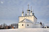 The White Sts. Peter and Paul Church on a Small Hill Covered Snow