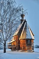 Old Wooden Church Framed by Tree in Winter Twilight