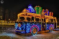 Illuminated New Year Bus With Gifts at Night