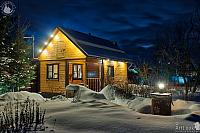 Illuminated Wooden House in a Winter Twilight