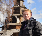 With background of the wooden church of the Transfiguration in Suzdal